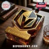 Vegas Golden Knights shaped whiskey decanter with gold metallic accents and Champions text on a wooden desk.!