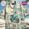 Short-sleeve button-down shirt with a teal Vespa and Italian coastal landscape print on a light cream background.!