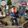 Warhammer 40k style Space Marine figurine holding a blue banner marked 40th Anniversary 1987-2027 in a hobby workshop.!