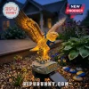 Solar-powered eagle garden light with yellow illumination, wearing a blue and yellow bandana, on a rock base marked Eagles.!