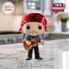 Willie Nelson stylized vinyl figure with a red bandana, grey braided hair, and acoustic guitar on a marble countertop.!