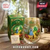 Wizard of Oz 87th anniversary stemless wine glass and green display box on a wooden table with printed movie graphics.!