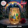 Wizard of Oz 87th anniversary stemless glass with Dorothy, Toto, and Emerald City graphics on a wooden table.!