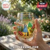 Wizard of Oz 87th anniversary stemless glass with Dorothy, Toto, and Emerald City print on a gold-rimmed clear surface.!