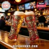 Two tall beer glasses with embossed gold Brahma Bull graphics, The Rock logo, and wrestling text on a bar background.!
