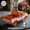 Translucent orange and white Ford F-150 model truck with a Crown Royal bottle cap topper on a slate surface.!