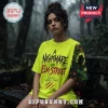 Neon yellow A Nightmare on Elm Street t-shirt with Freddy Krueger sleeve art worn by woman in foggy forest setting.!
