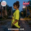 Woman wearing oversized neon yellow graphic t-shirt featuring Nightmare on Elm Street print on a residential street.!