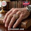 US Airborne Veteran commemorative ring with gold wings and American flag on a man's hand resting on an antique book.!