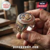Gold Airborne Veteran ring featuring a parachute emblem, US flag, and red and blue enamel accents on a wooden background.!