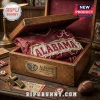 Alabama Crimson Tide Premium Distressed T-Shirt folded inside a wooden chest with vintage sports memorabilia.