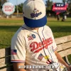Los Angeles Dodgers cream baseball jersey and cap featuring Snoopy, Woodstock, fireworks, and American flag graphics.!