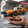 AMC AMX Route 66 Centennial Edition diecast car in orange and black with number 66 displayed on a person's palm.