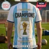 Argentina World Cup 2026 Champions Back to Back T-Shirt featuring light blue and white stripes with a gold trophy graphic.