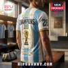 Argentina World Cup 2026 Champions Back to Back T-Shirt featuring light blue and white stripes, gold trim, and trophy graphic.