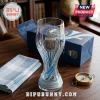Argentina World Cup Trophy Glass Beer Stein with AFA logo, three stars, and blue base, sitting on a wooden desk.