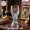 Argentina World Cup Trophy Glass Beer Stein with a gold rim, three stars, and the AFA crest on a wooden table surface.