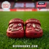 Arsenal FC 140th Anniversary Crocs with charms featuring club logos, soccer balls, and commemorative 1886 text on grass.