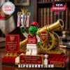 Arsenal FC brick mascot holding a Premier League trophy next to a gold cannon model on a red and gold base.!