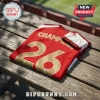 Red soccer jersey with gold CHAMPIONS text and number 26 resting on a wooden bench at a stadium.!