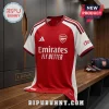 Arsenal FC red and white jersey with Adidas logo and Emirates Fly Better text on a wooden locker room bench.!