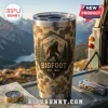 Stainless steel tumbler with camouflage pattern, Bigfoot graphic, and mountains against a mountain backdrop.!
