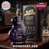 Black Sabbath Paranoid electric guitar shaped whiskey bottle with purple graphics, standing next to a matching gift box.!