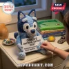 Crochet Bluey plush toy holding a card reading Charlie's Emotional Support Bluey with a small blue puzzle piece attachment.!