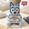 Blue crocheted Bluey dog plush toy holding a card reading Charlie's Emotional Support Bluey on a star patterned bed.!
