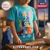 Child wearing a turquoise Bluey character t-shirt with a cartoon graphic of Bluey holding a pencil and test book.!