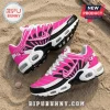 Pink and white running sneakers featuring breast cancer awareness ribbons and the word HOPE on a sand background.!