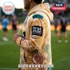 Tan hoodie featuring First Nations dot art print and First Mac Captains logo, worn by a person on a sports field.!