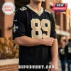 New Orleans Saints black football jersey featuring number 89, gold lettering, team logo, and NFL shield patch.!