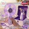 BTS Army purple LED hand fan with printed logo and text spinning on a beach table near a boxed fan and matching wrist strap.