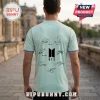 Man wearing a light green t-shirt with a black BTS logo and seven band member signatures on the back.!