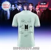 Light green short-sleeve shirt featuring black BTS logo and member signatures on the back with striped sleeve trim.!
