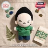 BTS Min Yoongi Grumpy Face Plush Doll wearing a green striped polo shirt and blue jeans on a textured linen background.