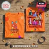 BTS Permission To Dance Orange T-Shirt showing band members, logo, and graphic prints on a wooden surface.
