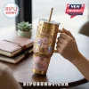 BTS x BT21 Cosmic Friends gold stainless steel tumbler featuring embossed character graphics and a metal straw.