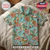 Button-up shirt with all-over print of Calvin and Hobbes characters, tropical leaves, and hibiscus flowers on light blue.!