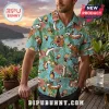 Man wearing a light blue tropical shirt featuring Calvin and Hobbes print, palm leaves, and hibiscus flowers.!