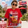 Woman wearing red t-shirt with Chick-fil-A logo, American flag, waffle fries, and chicken sandwich graphics outdoors.!