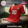 Portugal national soccer team jersey in red with green trim, Puma logo, and white number 00 on a leather bench.!