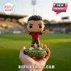 Cristiano Ronaldo vinyl figure in Portugal kit standing on a green base labeled Six World Cups in a soccer stadium.!