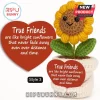 Crocheted sunflower toy in a white pot with a red heart sign bearing text about friendship on a white background.!