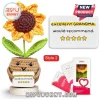 Crochet sunflower in tan pot holding a sign reading excellent GRANDMA would recommend with five yellow stars on wood base.!