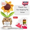 Crocheted sunflower in a tan yarn pot holding a sign reading Thank You For Helping Me Grow on a circular wooden base.!