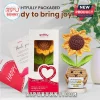 Crocheted sunflower in a tan pot with a smiling face and a sign reading May you be proud of the work that you do.!