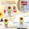 Crocheted sunflower in a tan pot holding a sign with positive text, mounted on a small wooden base.!