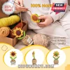 Crochet sunflower in a smiling yarn pot with a motivational message tag, surrounded by skeins of yellow and brown wool.!